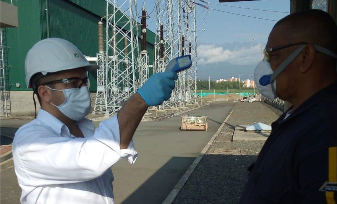 GEB worker takes another worker’s temperature at the infrastructure control post.