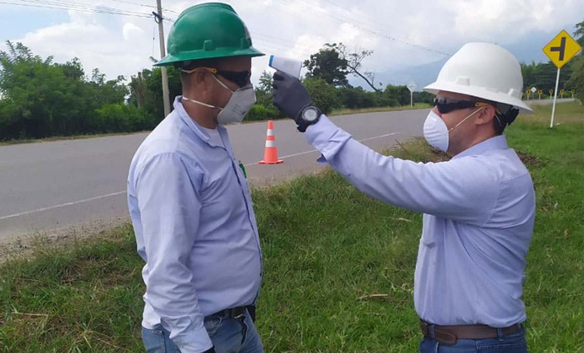 GEB worker takes another worker’s temperature at the infrastructure control post.