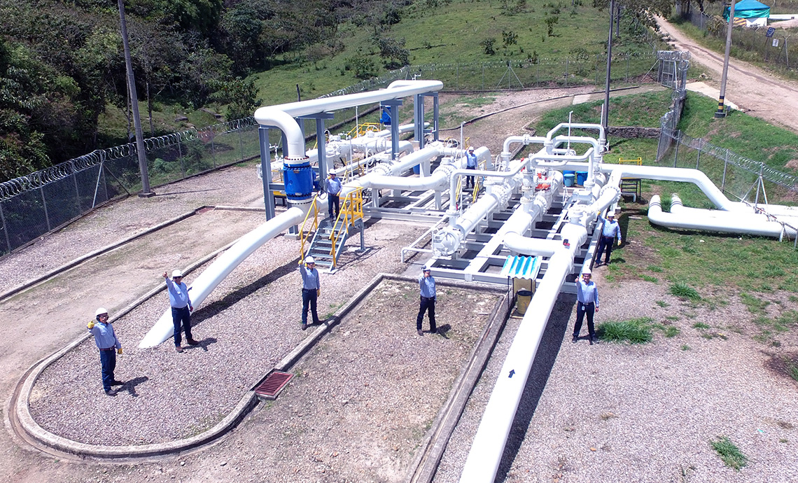 Air shot of six TGI workers at a compression station.